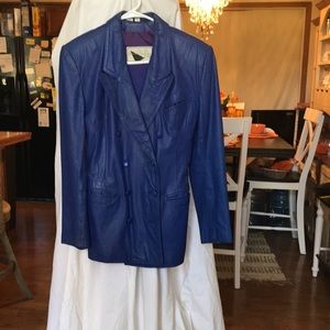 Two piece leather suit double breast skirt has kick pleat.